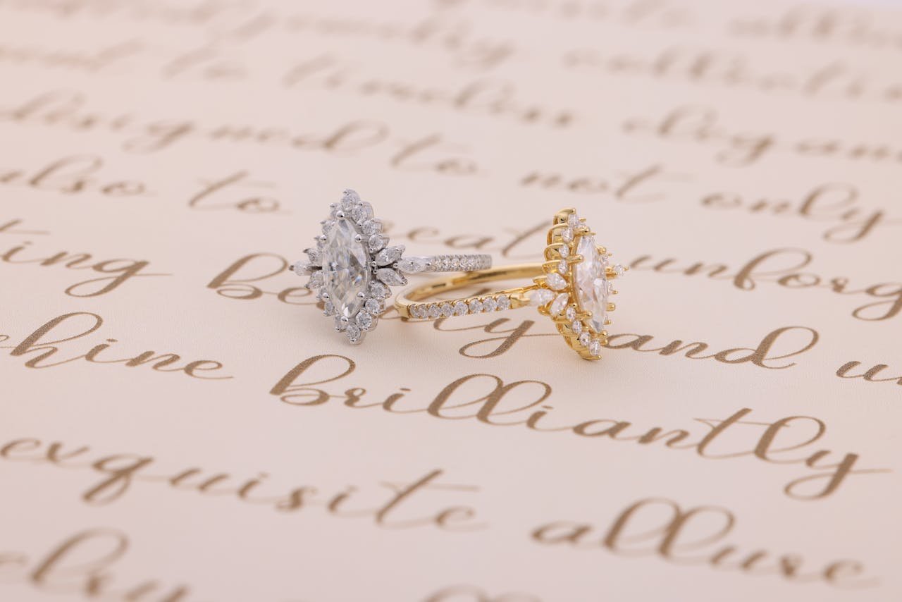 Elegant diamond engagement rings displayed on handwritten calligraphy paper.