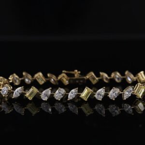 Luxurious diamond and gold bracelet reflecting on a black surface, showcasing elegance and sophistication.